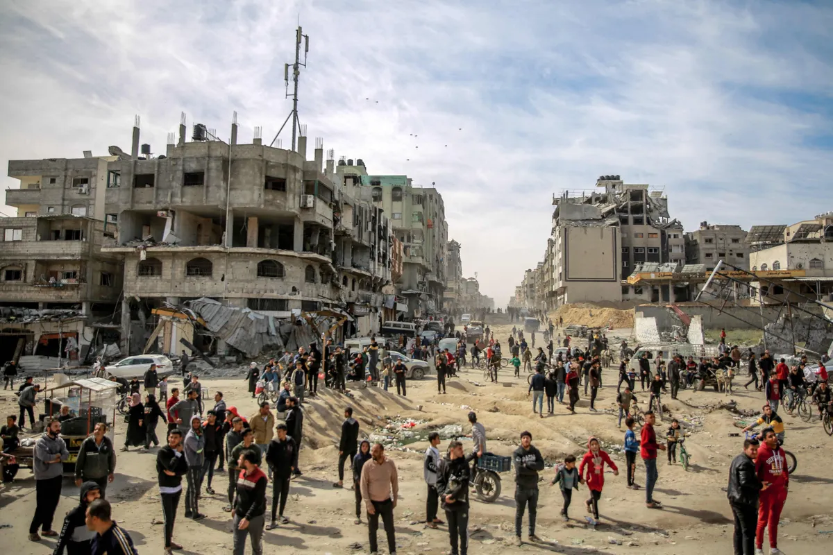 106084866 Topshot Palestinians Gather In A Street As Humanitarian Aid Is Airdropped In Gaza City O